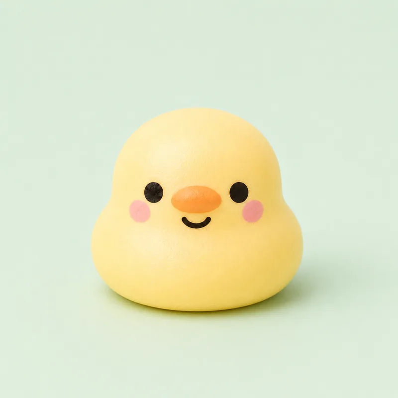A yellow duck squishy with an orange beak and a smiling face