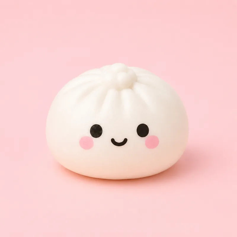 A white pleated dumpling squishy with a smiling face on a pink background