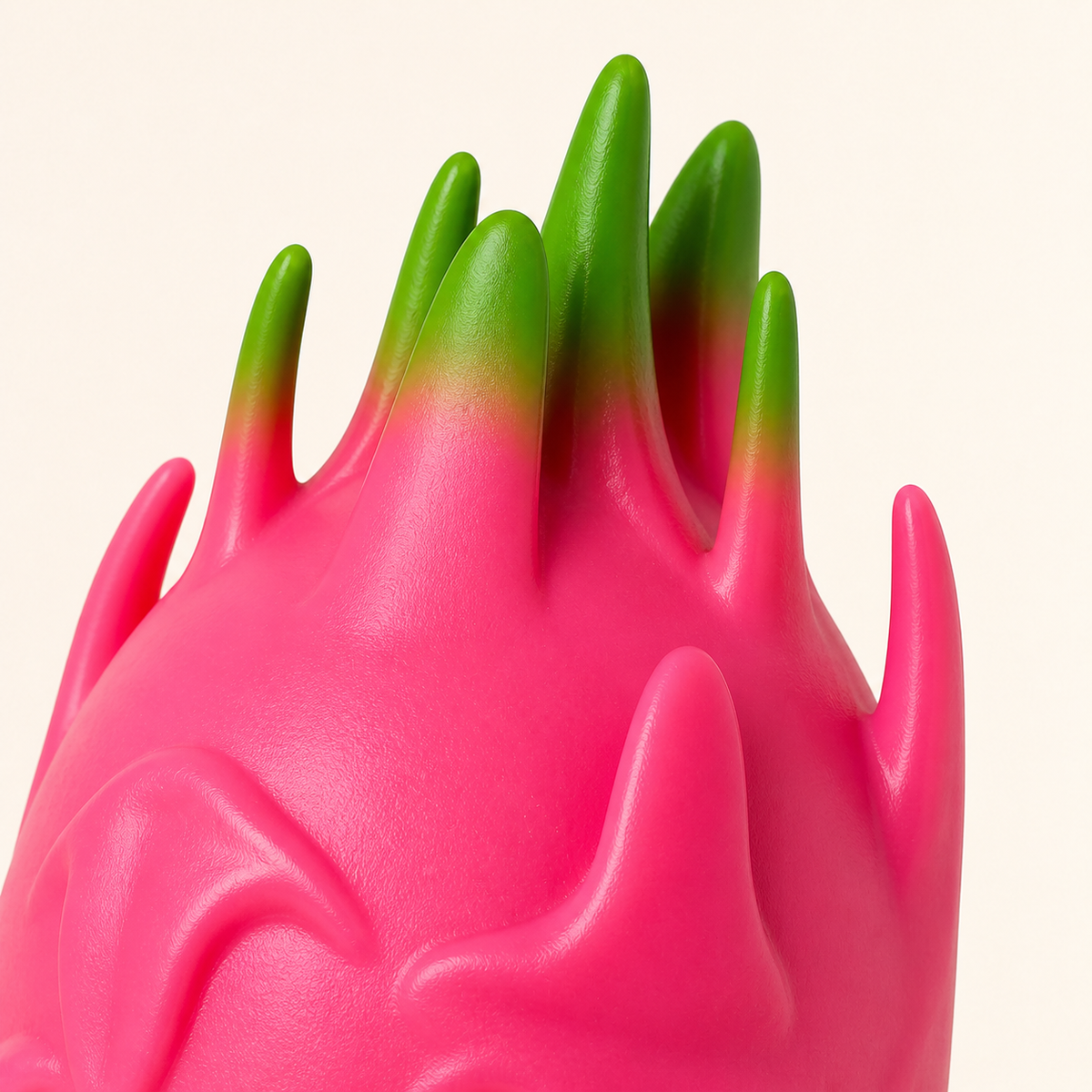 Close-up of the pink molded fins and green tips on the dragon fruit squeeze ball