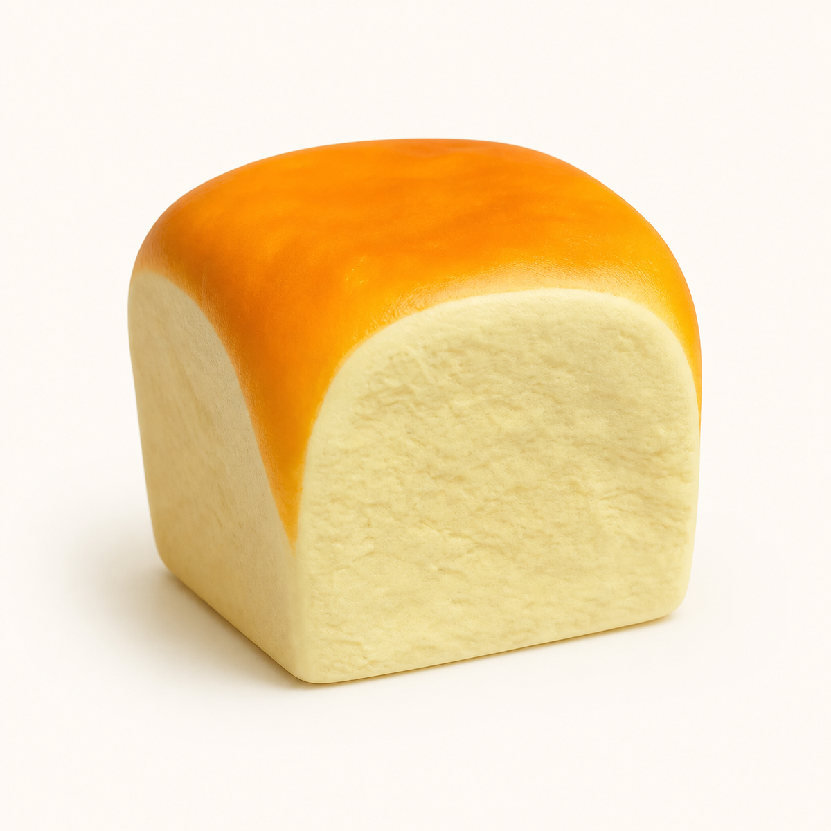 Soft bread loaf squishy toy with a smooth domed top on a cream background