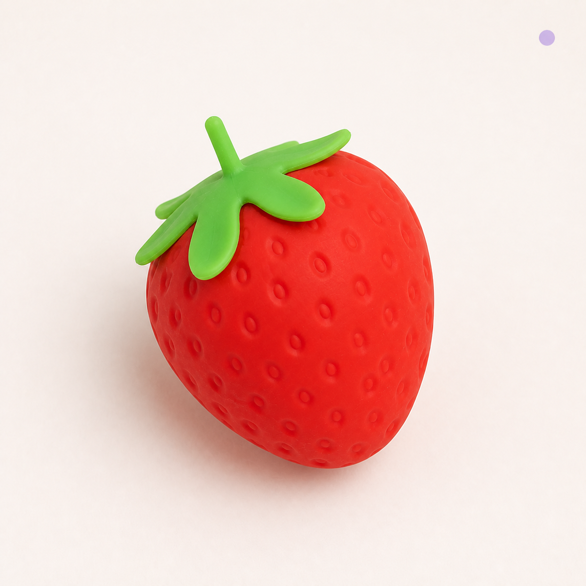 Close-up of Strawberry Slow-Rise Squishy seed texture and green leafy top